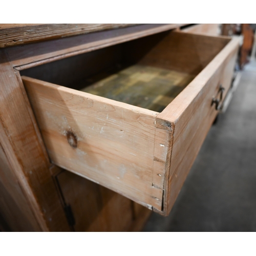 90 - Antique pine dresser base with two drawers over panelled cupboard doors (one loose handle, in drawer... 