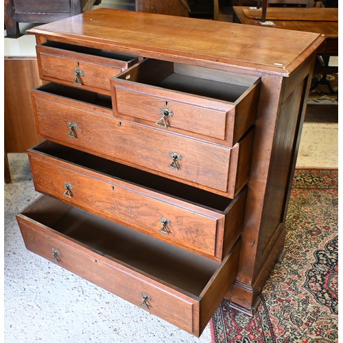 538 - An Arts & Crafts hardwood chest of two short over three long graduated drawers with brass handle... 