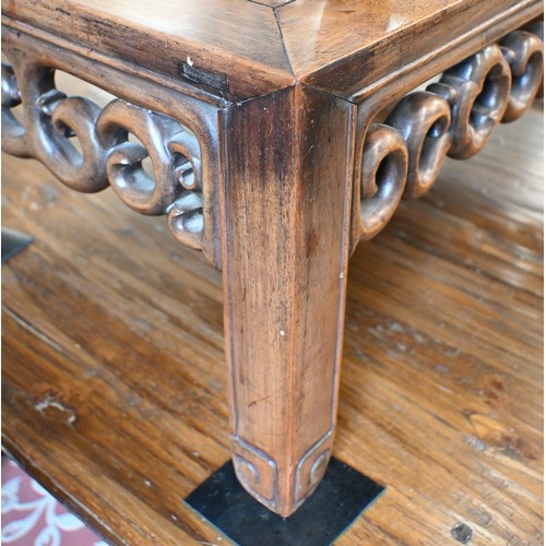 116 - A Chinese hardwood coffee table with fret-cut scroll frieze, 76 x 40 x 28 cm to/w a similar smaller ... 