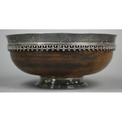 62 - Omar Ramsden: a silver-mounted turned maple wood mazer bowl, the flaring silver rim applied with ban... 