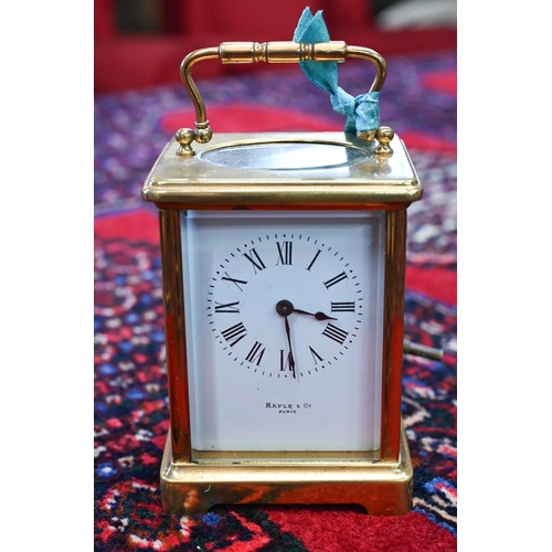 464 - # A brass carriage clock, retailed by Maple & Co., Paris, 15 cm high o/a, to/w another clock wit... 