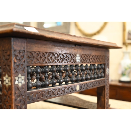 108 - A late 19th century Syrian profusely carved hardwood occasional table inlaid with mother-of-pearl st... 