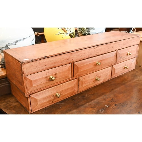 121 - A vintage pine table top tool chest with seven drawers, 90 x 22 x 27 cm h, to/w an Edwardian pine ca... 