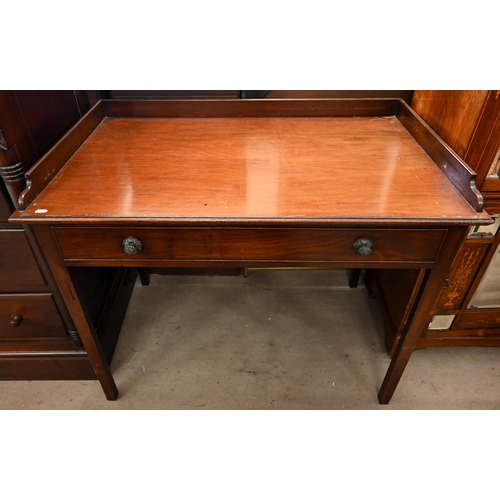 126 - An early 19th century mahogany writing table with three quarter gallery top and long frieze drawer, ... 