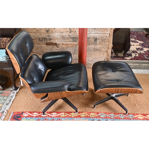 131 - A classic Eames style swivel armchair to/with a matching footstool, buttoned black leather and plywo... 