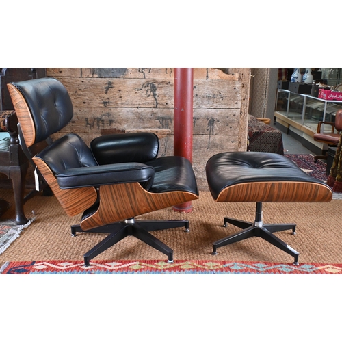 131 - A classic Eames style swivel armchair to/with a matching footstool, buttoned black leather and plywo... 