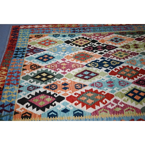 132 - A contemporary Turkish Kelim carpet, the multi-coloured diamond design on camel ground, 296 cm x 200... 