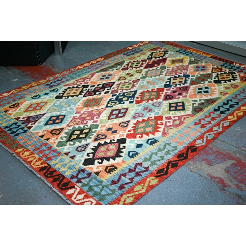 132 - A contemporary Turkish Kelim carpet, the multi-coloured diamond design on camel ground, 296 cm x 200... 