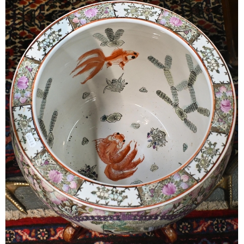 136 - A large Chinese famille rose jardiniere/fish bowl on wooden stand to/with a pair of cast polished br... 