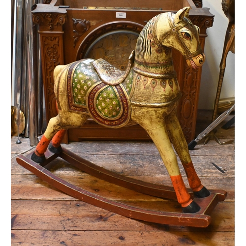 138 - A small Indian polychrome painted wooden rocking horse, 77 cm long x 72 cm h