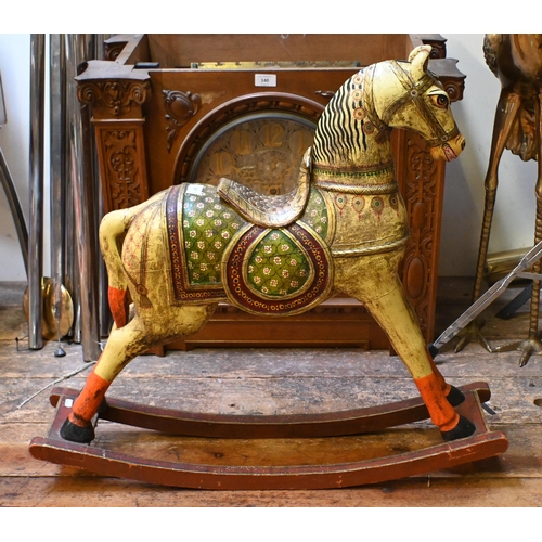 138 - A small Indian polychrome painted wooden rocking horse, 77 cm long x 72 cm h