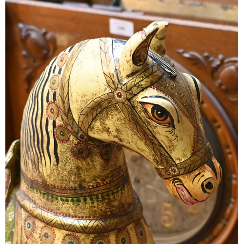 138 - A small Indian polychrome painted wooden rocking horse, 77 cm long x 72 cm h