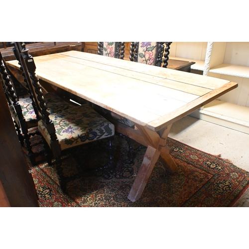 159 - An old pine kitchen table, the cleated end top raised on 'X' frame ends united by a stretcher, 184 x... 