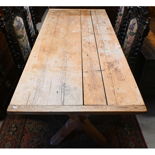 159 - An old pine kitchen table, the cleated end top raised on 'X' frame ends united by a stretcher, 184 x... 