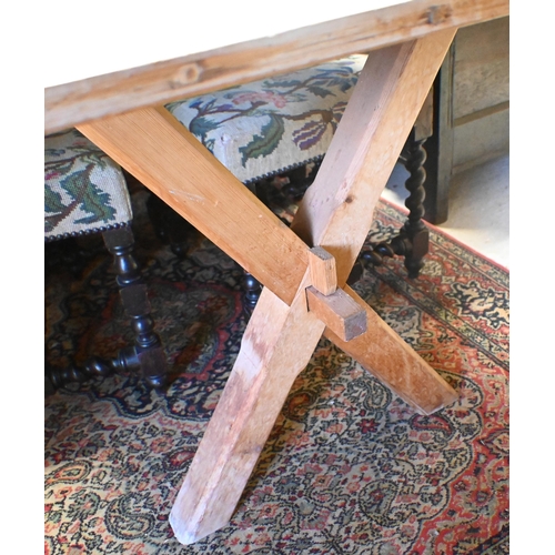 159 - An old pine kitchen table, the cleated end top raised on 'X' frame ends united by a stretcher, 184 x... 