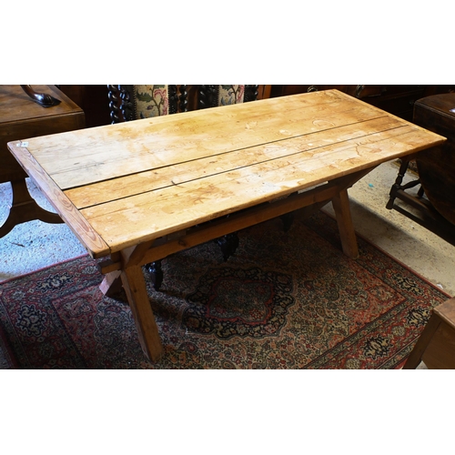 159 - An old pine kitchen table, the cleated end top raised on 'X' frame ends united by a stretcher, 184 x... 