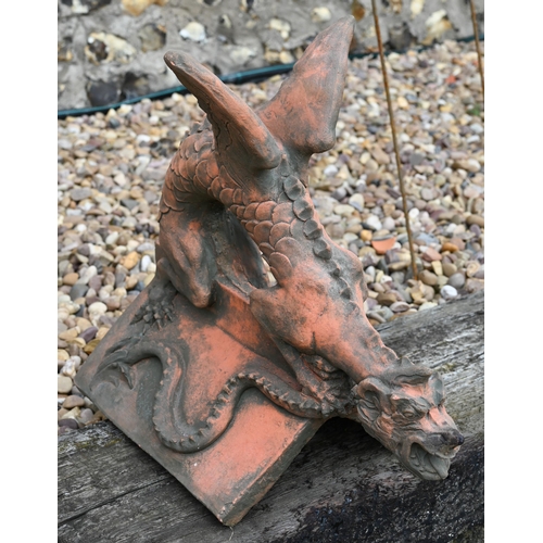 19 - A reconstituted cast stone 'Brighton Dragon' ridge tile, aged terracotta finish, 44 cm high