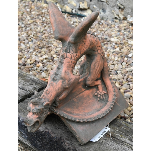 19 - A reconstituted cast stone 'Brighton Dragon' ridge tile, aged terracotta finish, 44 cm high