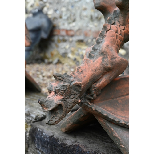 19 - A reconstituted cast stone 'Brighton Dragon' ridge tile, aged terracotta finish, 44 cm high