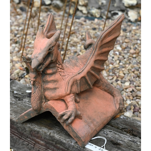 20 - A small reconstituted cast stone 'Brecon Dragon' ridge tile in aged terracotta finish, 34 cm high