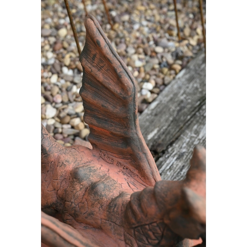 20 - A small reconstituted cast stone 'Brecon Dragon' ridge tile in aged terracotta finish, 34 cm high