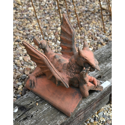 20 - A small reconstituted cast stone 'Brecon Dragon' ridge tile in aged terracotta finish, 34 cm high