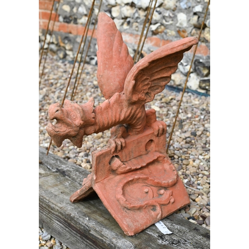 21 - A large cast reconstituted stone 'Welsh Dragon' ridge tile in aged terracotta finish, 60 cm high