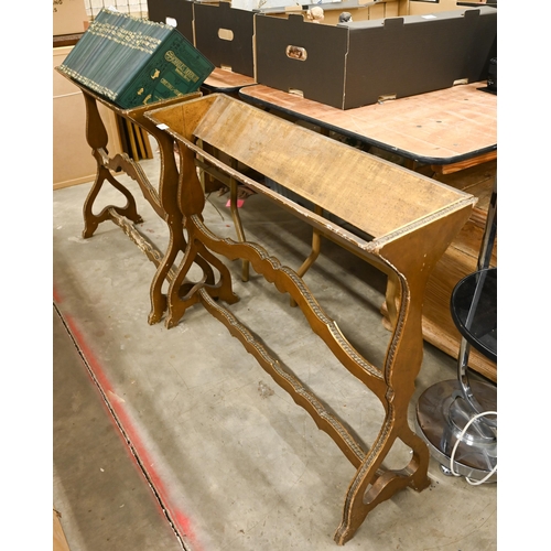 A pair of antique giltwood book-troughs on scrolling frames with guilloche-carved details, 92 cm wide (2)