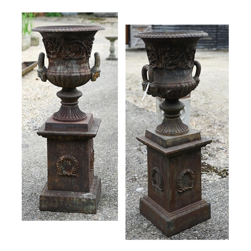 30 - A large pair of old weathered cast iron Campagna urn planters, raised on square pedestal bases, 112 ... 