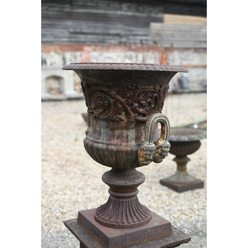 30 - A large pair of old weathered cast iron Campagna urn planters, raised on square pedestal bases, 112 ... 