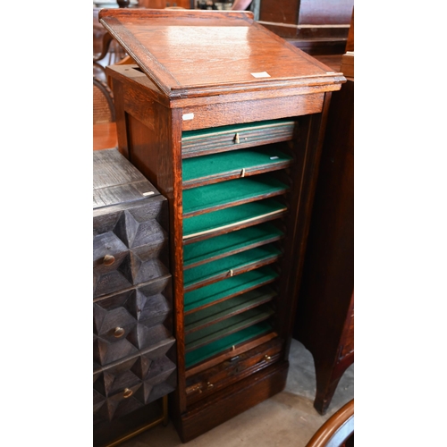 31 - An oak Lebus-style collector's chest with baize lined shelves enclosed by tambour fall front beneath... 