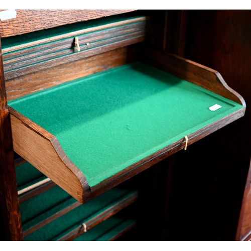 31 - An oak Lebus-style collector's chest with baize lined shelves enclosed by tambour fall front beneath... 