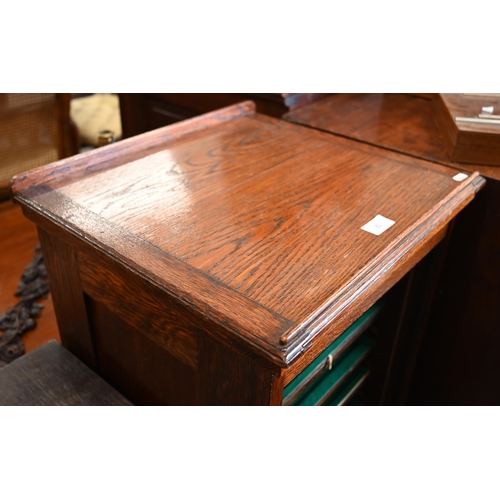 31 - An oak Lebus-style collector's chest with baize lined shelves enclosed by tambour fall front beneath... 