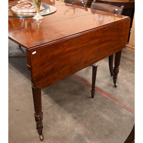 35 - A Regency telescopic dining table with drop ends and two leaf inserts, on turned and reeded supports... 