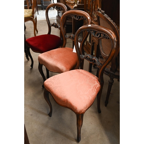 36 - # A set of five Victorian rosewood semi-balloon back dining chairs with carved back rails and stuff-... 