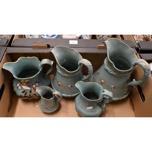 420 - Three Victorian Ridgway green-glazed jugs in differing sizes, with moulded decoration and floral pri... 