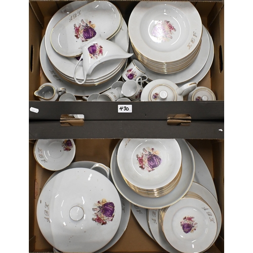 430 - A Limoges dinner service, printed with an 18th century couple and gilt initials 'ABK' (2 boxes)