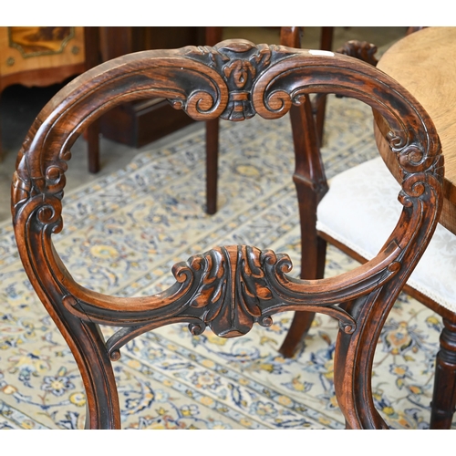 45 - # A set of four early Victorian rosewood dining chairs with carved backs and stuff over seats, on sw... 