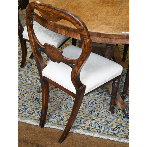 45 - # A set of four early Victorian rosewood dining chairs with carved backs and stuff over seats, on sw... 