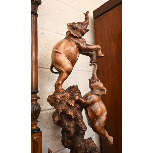 470 - An African carved wood arrangement of acrobatic elephants, 103 cm