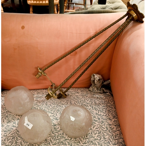 474 - An Art Deco brass ceiling light with three frosted glass globe shades, 75 cm high approx