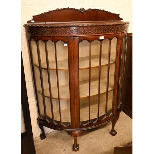 53 - A mahogany bowfront display cabinet on claw and ball feet, 107 cm