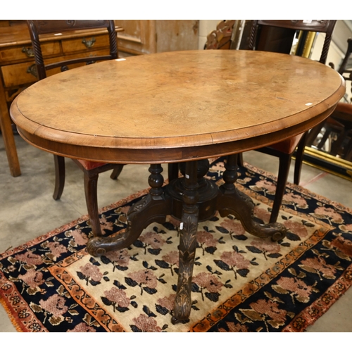 61 - A Victorian burr walnut loo table with oval tilt-top on turned pillars and swept carved supports, 12... 