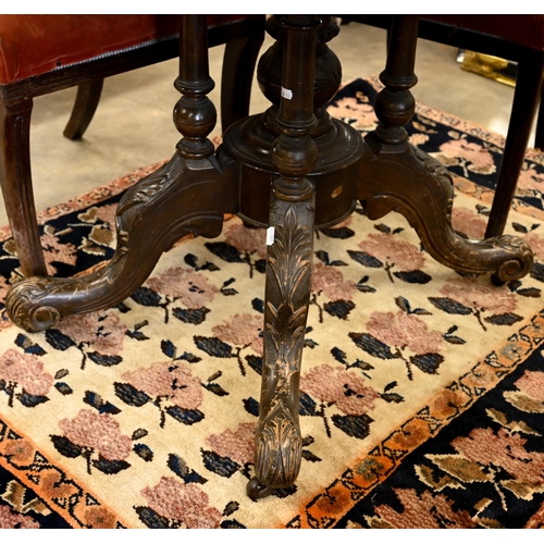 61 - A Victorian burr walnut loo table with oval tilt-top on turned pillars and swept carved supports, 12... 