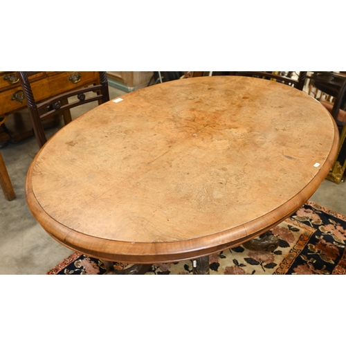 61 - A Victorian burr walnut loo table with oval tilt-top on turned pillars and swept carved supports, 12... 