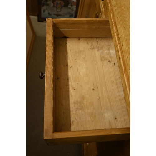 66 - A vintage waxed pine dresser with plate rack over three drawers and panelled cupboard doors, 140 cm ... 