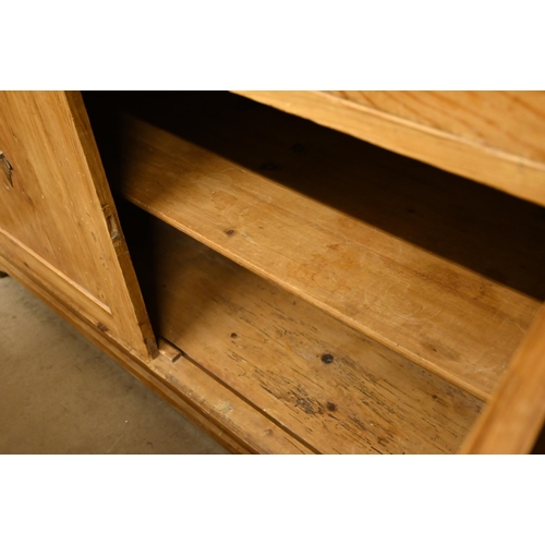 66 - A vintage waxed pine dresser with plate rack over three drawers and panelled cupboard doors, 140 cm ... 