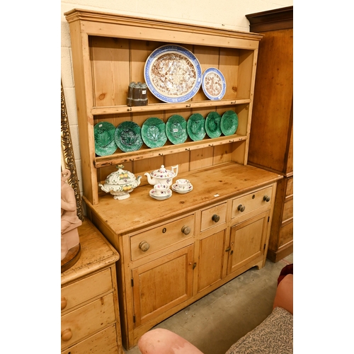 67 - A vintage pine dresser with plate rack over a panelled base with cupboards and three drawers, 145 cm... 