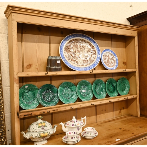 67 - A vintage pine dresser with plate rack over a panelled base with cupboards and three drawers, 145 cm... 