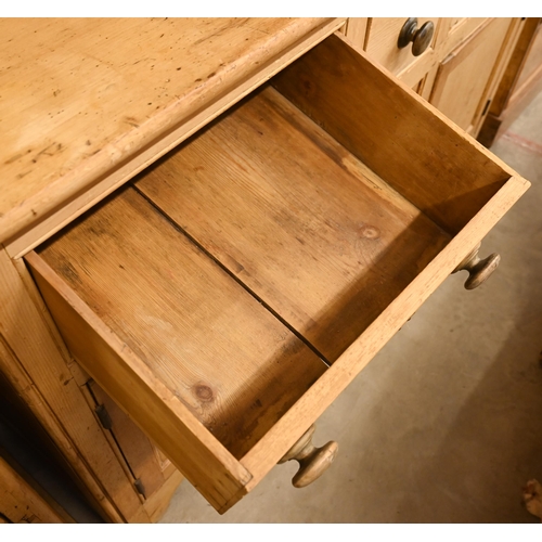 67 - A vintage pine dresser with plate rack over a panelled base with cupboards and three drawers, 145 cm... 